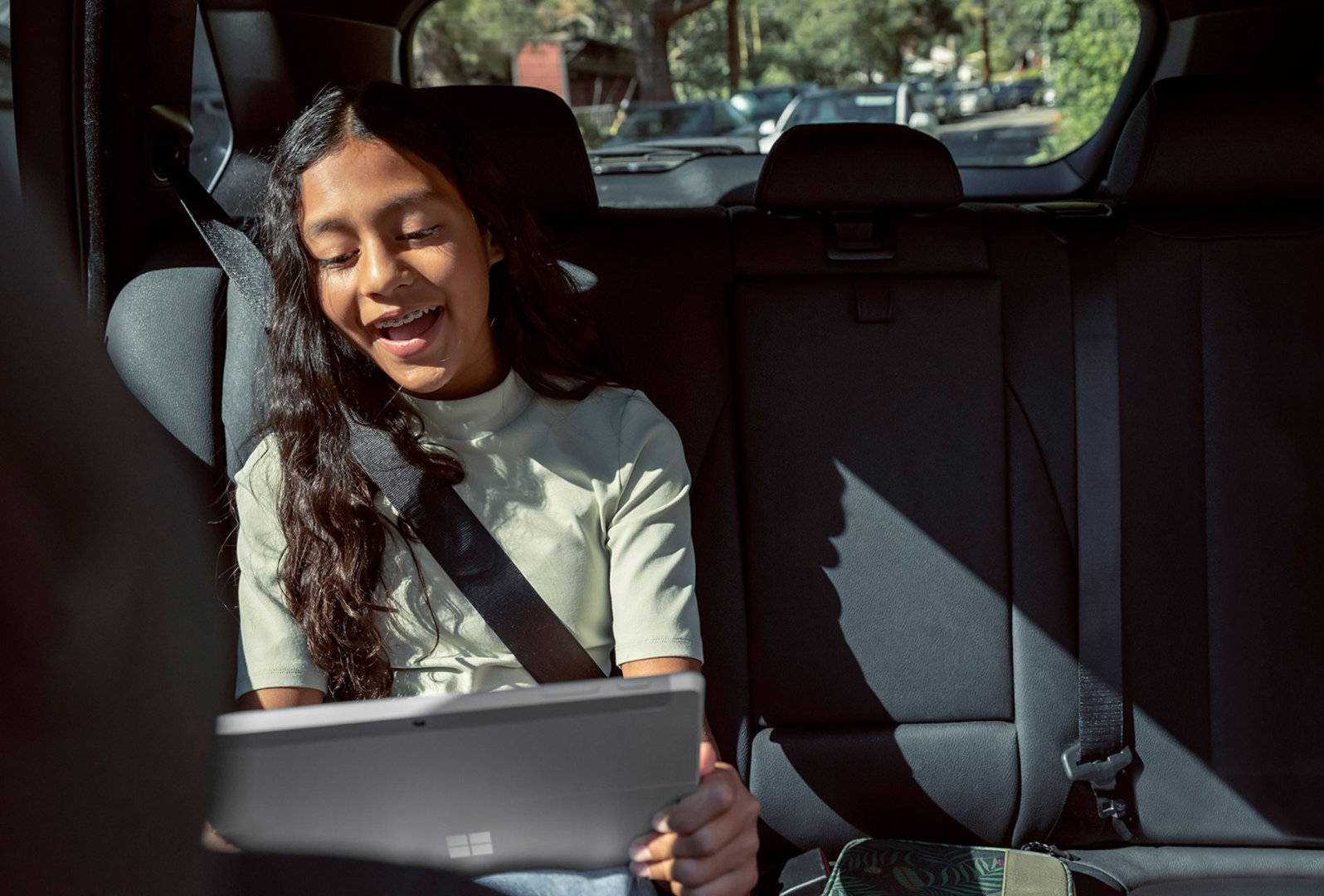 Seorang anak menggunakan Surface Go 3 di dalam kereta.