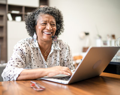 A women working with a laptop having microphone