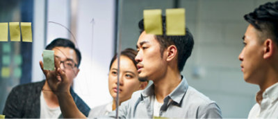 A group of people looking at a glass wall