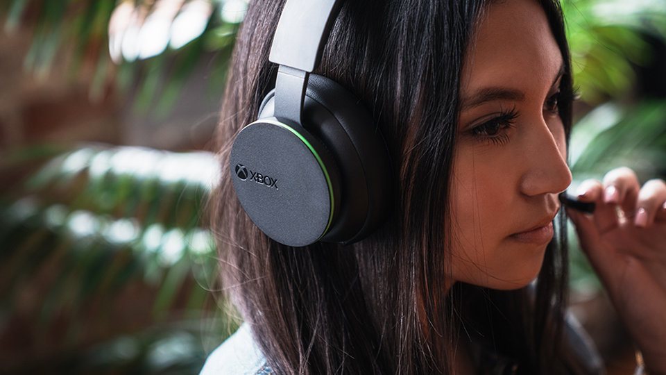 A person adjusts the microphone on the Xbox Wireless Headset.
