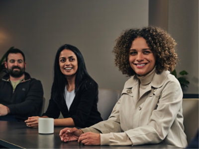 A group of people sitting in conference room and smiling