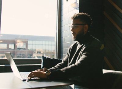 A man working on laptop in an office.