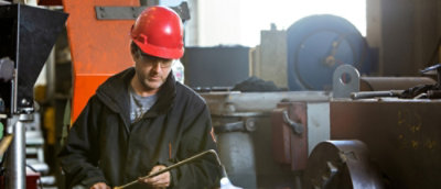 A man wearing a hard hat and a red helmet.