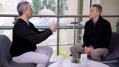 Two people are talking to each other sitting on the chair.