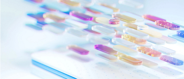 Assorted colorful capsules in a soft focus, placed in rows on a light blue, speckled background.