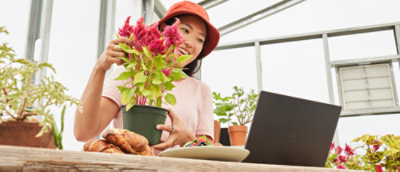 A woman holding a potted plant.