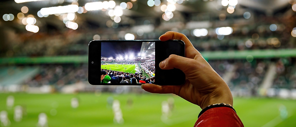 A person taking a picture of a sports field