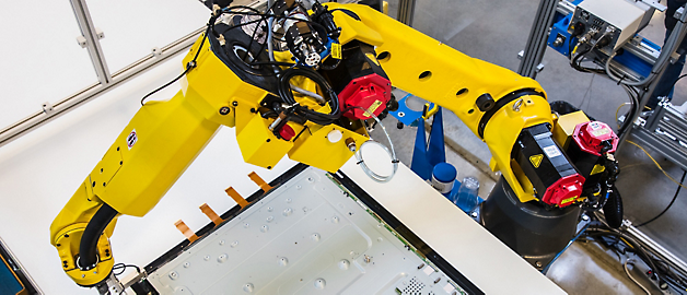 Industrial robot arm performing precision work on an assembly line.