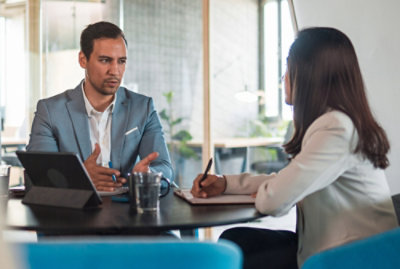 A man and woman sitting at a table.