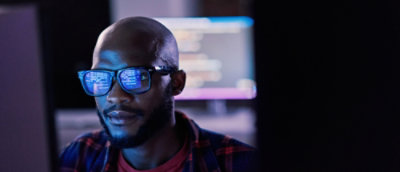 A close-up of a man's face wearing sunglasses.