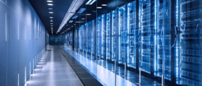 A long hallway with blue walls and glass panels.
