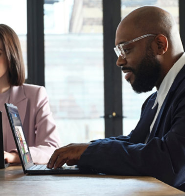 A man and women working on computer.
