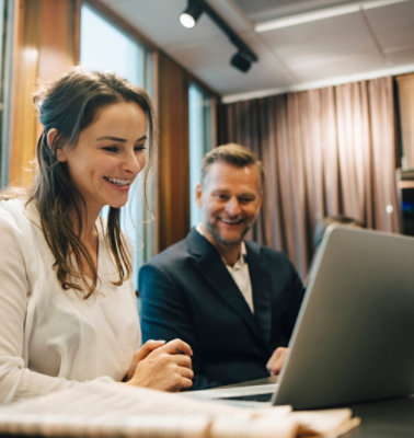 Two people working on computer