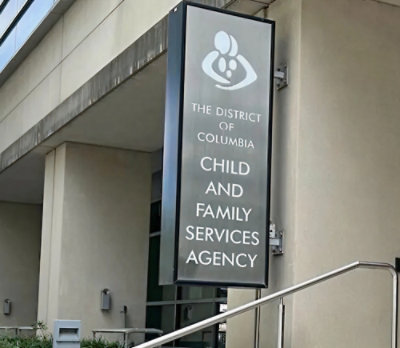 A sign on a building with the text THE DISTRICT OF COLUMBIA CHILD AND FAMILY SERVICES AGENCY.