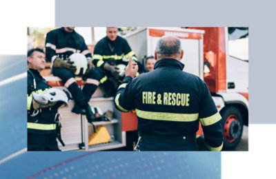 A group of firefighters in uniform with the text FIRE & RESCUE visible on a jacket.