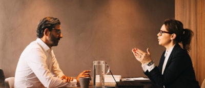 A group of people sitting and talking at a table.