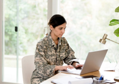 A military women working on laptop.