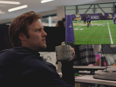 A person with cup in his hand and watching at screen