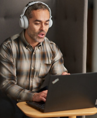  A person sitting at a table using a laptop