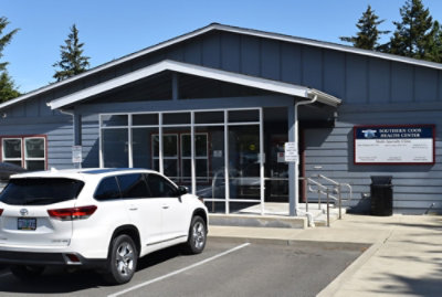 A white car parked outside a building.