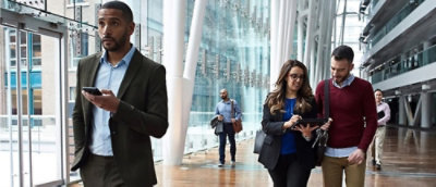 A group of people walking in a hallway