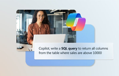 A woman wearing glasses and a brown shirt sitting at a computer with a sign displaying SQL query instructions.