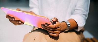 A women holding a tab