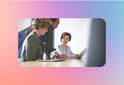 A group of people looking at a laptop.