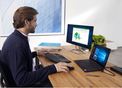 A man sitting at a desk using a computer.