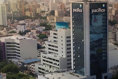 A high rise building with many windows overlooking a city.