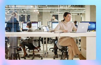 A woman sitting at a desk using a laptop