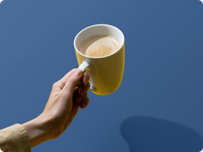 A hand holding a cup of coffee