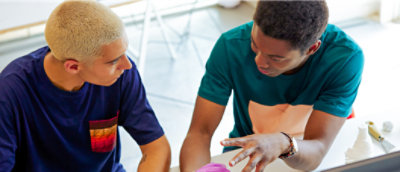 Two people sitting and talking with each other. 