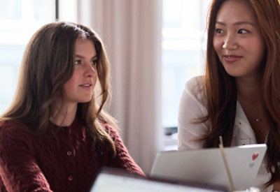 A person sitting at a desk with multiple computer