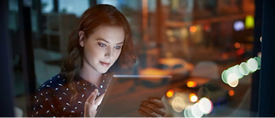 A woman looking at a tablet.