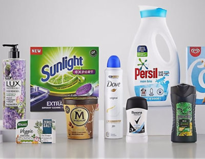 A variety of household and food products displayed on a table with visible brand labels.