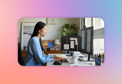 A woman sitting at a desk using a computer.