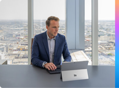 A man sitting at a desk with a laptop.