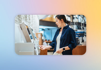 A woman wearing a blue shirt looking at a computer screen