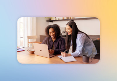 Two people checking something in a laptop