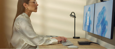 A woman sitting at a desk using a computer.