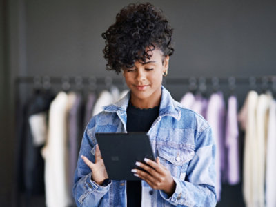 A woman holding a tablet.