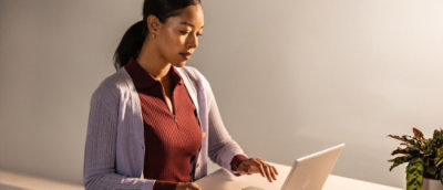 A woman using a laptop.