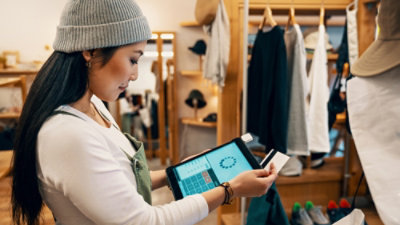 A holding laptop and purchasing in store