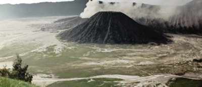 A mountains in the background and greenery around it