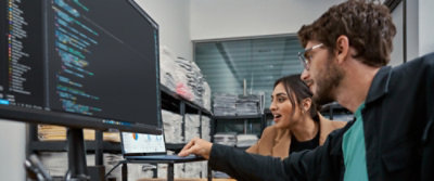 A man and woman looking at a computer screen