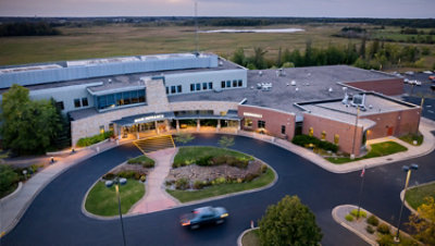 Takewood Health System building with a parking lot and grass field.