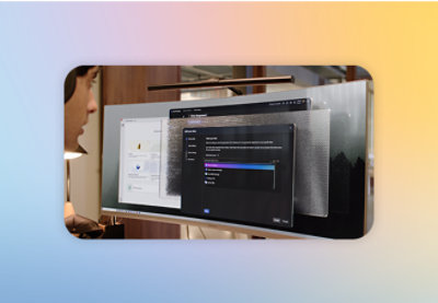 A man wearing headphones looking at a computer screen with text on it.