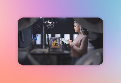 A woman sitting at a desk reading a book