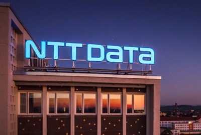 A building with a sign on top displaying NTT DATA.